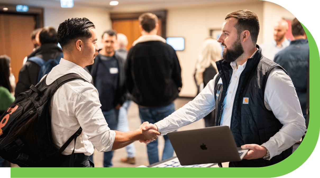 Photo of two attendees shaking hands