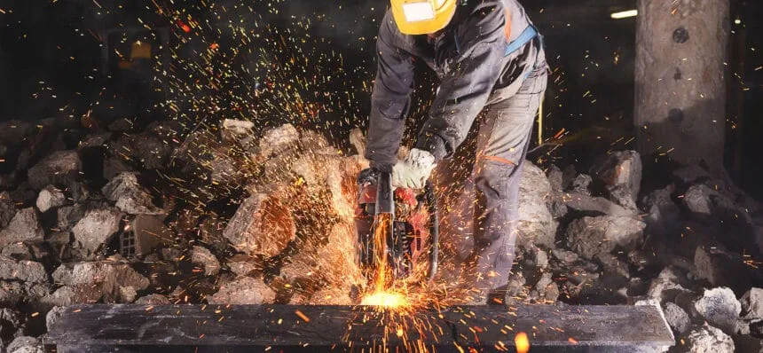 Construction worker cutting an iron beam.