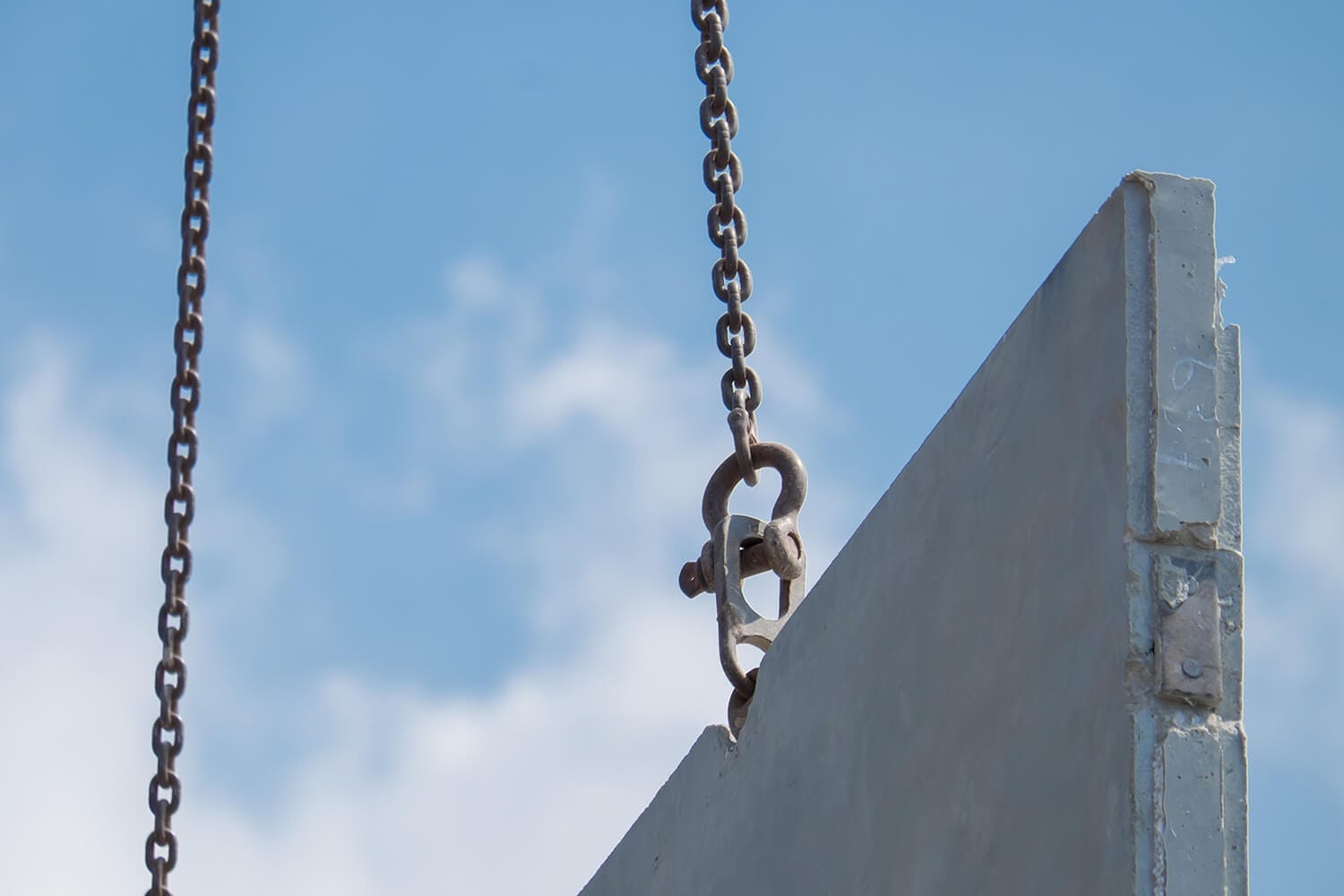 Crane lifting a precast concrete panel into place