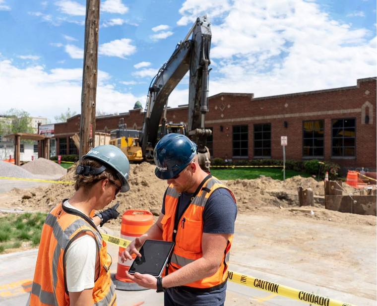 Project leaders reviewing live job data on site
